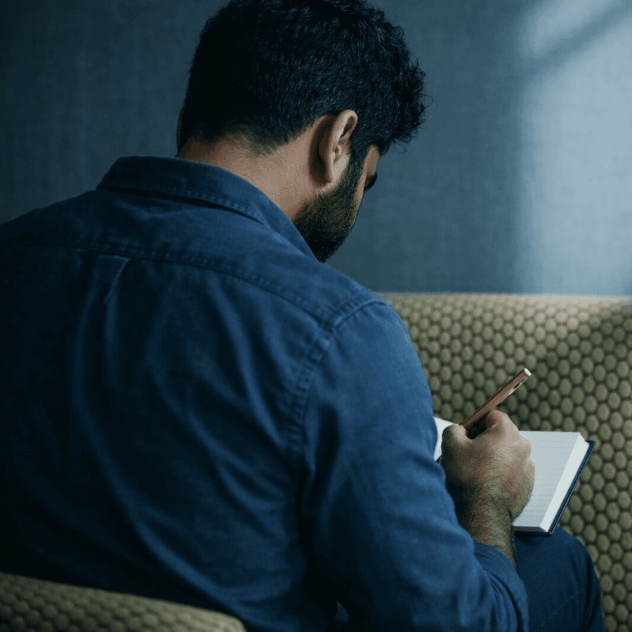 A man writing notes in a notebook